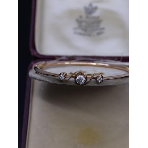 53 - A diamond set bangle with a copy of a valuation from Paul Sherrans which state A rose gold bangle ap... 