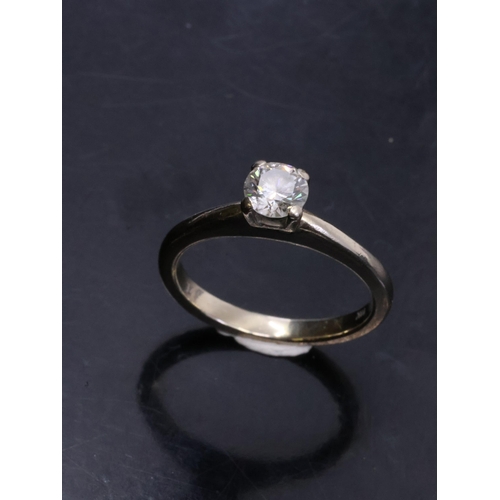 54 - A diamond solitaire ring set in 14kt gold with a UGS cert which states the diamond is 0.50cts I colo... 