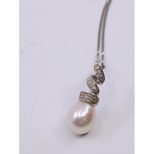 6 - A diamond and pearl set pendant on a gold chain