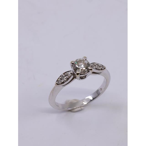 9 - A diamond solitaire ring set in 18ct gold