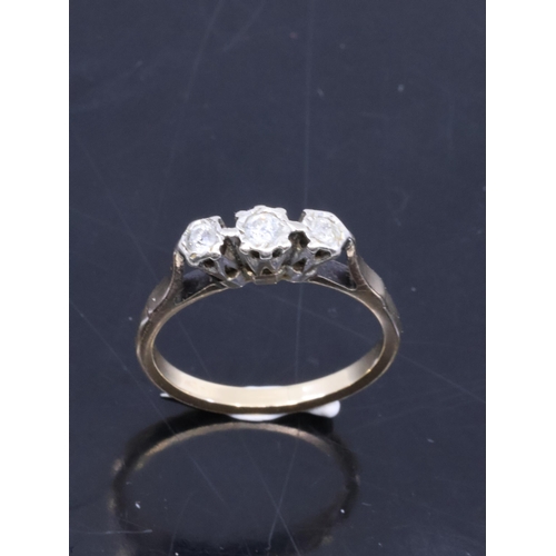 12 - A diamond set three stone ring set in 9ct gold approx. 2.8 grams, showing as finger size N