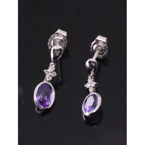 123 - A pair of diamond and amethyst set earrings approx. 2.3 grams