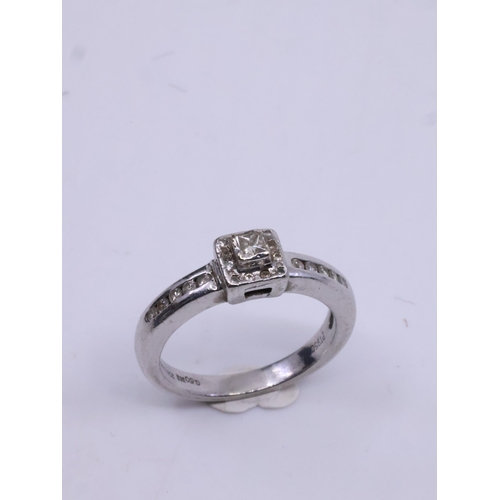 21 - A diamond solitaire ring set with diamond shoulders in platinum, total estimated weight of diamonds ... 