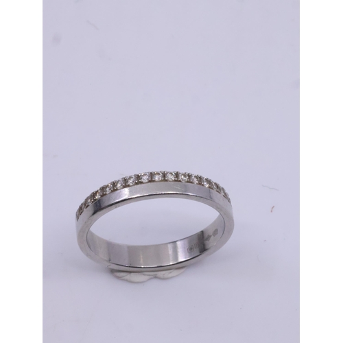 22 - A diamond set platinum band approx. 3.5 grams, showing as finger size I and a half