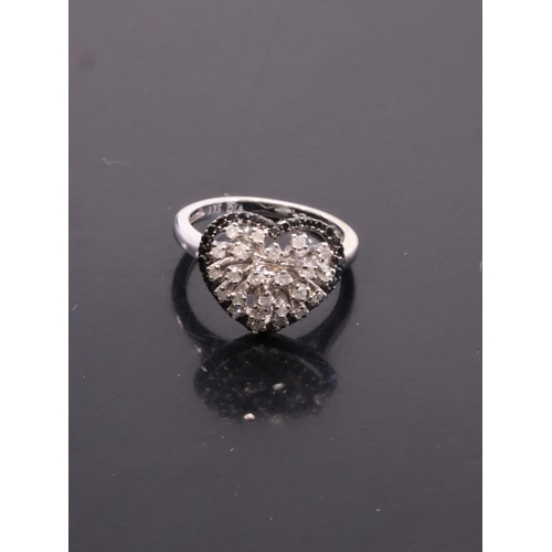 32 - A black and white diamond cluster finger size L set in 9ct gold