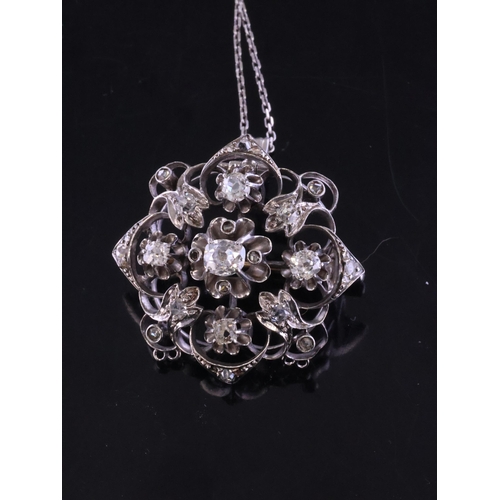 41 - A diamond cluster pendant/brooch set in 14kt gold on a silver chain