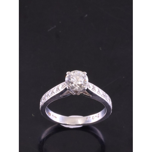 56 - A diamond solitaire ring set with diamond shoulders finger size J with a copy of a valuation from Ap... 