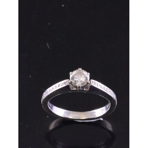 84 - A diamond solitaire ring set with diamond shoulder in 18kt gold finger size L