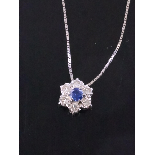 198 - A sapphire and diamond cluster pendant on 9ct gold chain