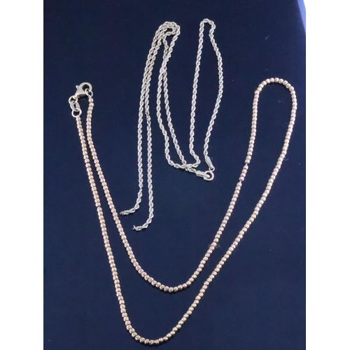 216 - Two 18ct gold chains, total weight 9.1 grams (one chain broken)