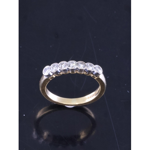 31 - A diamond set half eternity ring set in 18ct gold, showing as finger size J and a half