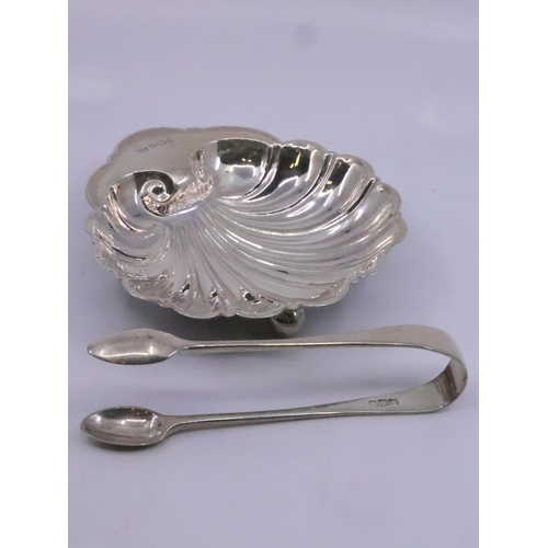 327 - A silver shell butter dish and a silver sugar tongs total weight approx. 126 grams, To be sold on th... 