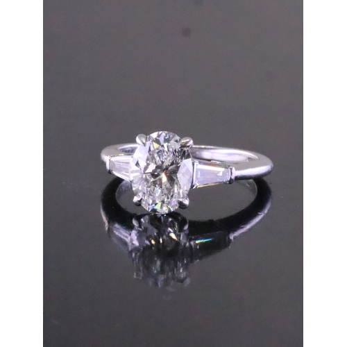 245 - A fine Tiffany diamond solitaire ring set with diamond shoulders in platinum, finger size L half, wi... 