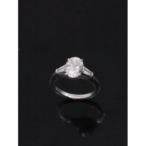 245 - A fine Tiffany diamond solitaire ring set with diamond shoulders in platinum, finger size L half, wi... 