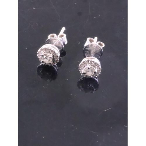 101 - A pair of diamond cluster earrings