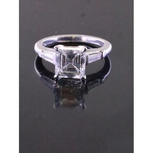 106 - A fine emerald cut diamond solitaire ring set with diamond shoulders with a GIA certificate which st... 