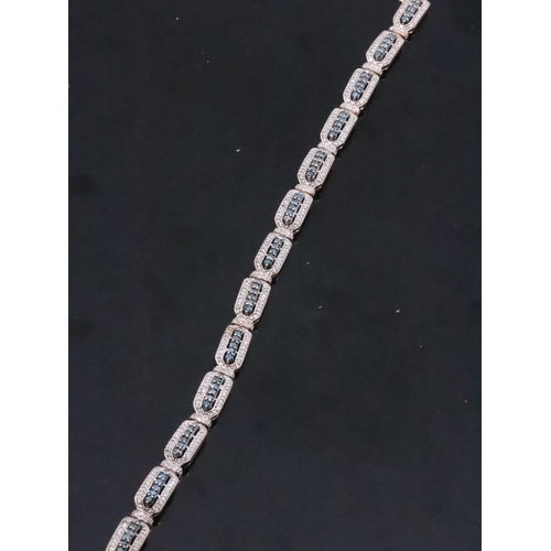 110 - A diamond and sapphire set 9ct gold bracelet