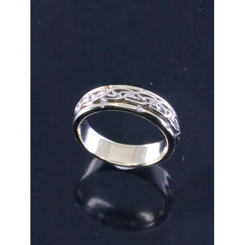 82 - A 14ct gold Celtic style ring, estimated weight  6.4g finger size O