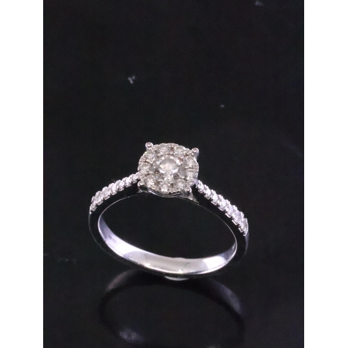 98 - A diamond cluster ring set in 18ct gold with a copy of a valuation which states the diamond weight i... 