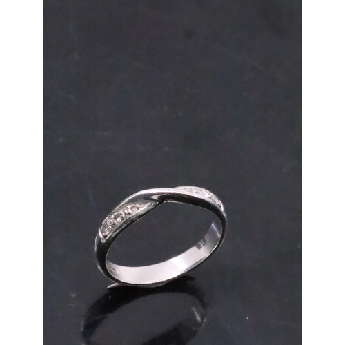 21 - A diamond set band ring set in platinum finger size L set in platinum