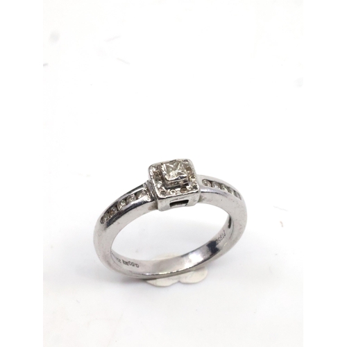 4 - A diamond solitaire ring set with diamond shoulders in platinum, total estimated weight of diamonds ... 