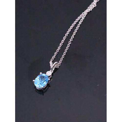 47 - A diamond and topaz set pendant in 18ct gold on an 18ct gold chain approx. 3.2 grams