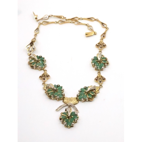 57 - A diamond and emerald set gold necklace approx. 46.6 grams