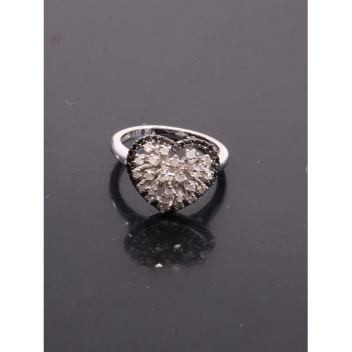 7 - A black and white diamond cluster finger size L set in 9ct gold