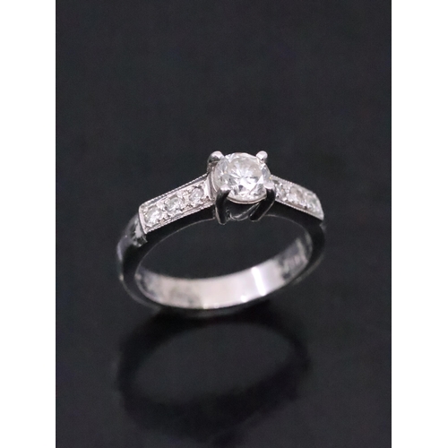 24 - A diamond solitaire ring set in 18ct gold set with diamond shoulders estimated weight of diamond 0.4... 