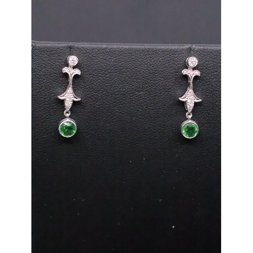 39 - A pair of diamond and green gem stone earrings set in 18ct gold