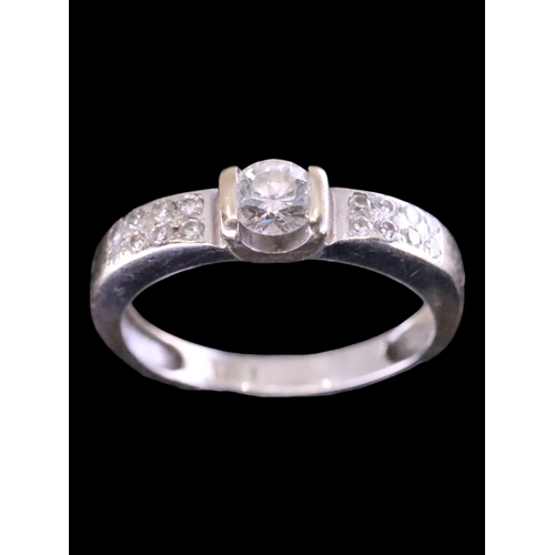 18 - A diamond solitaire ring set with diamond shoulders with a GIA certificate which states the diamond ... 