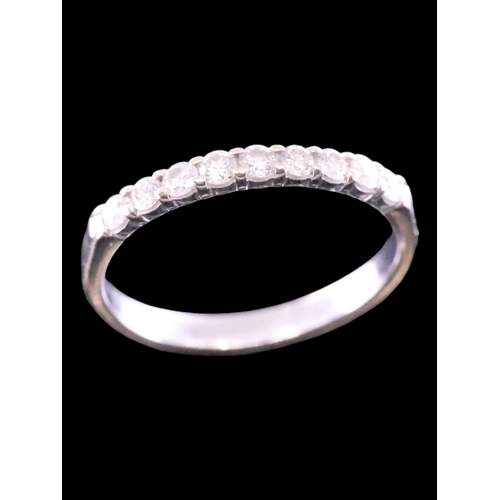 189 - A diamond half eternity ring set in 14kt gold finger size K