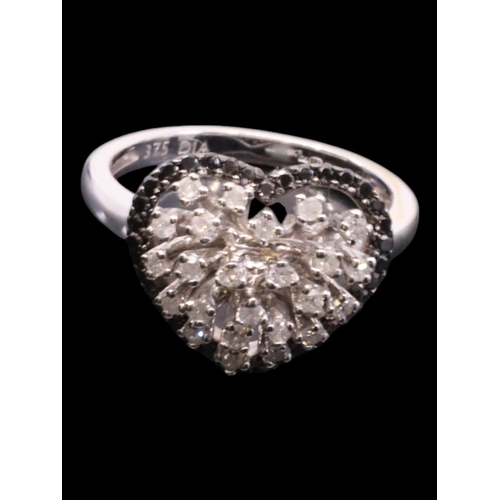 2 - A black and white diamond cluster finger size L set in 9ct gold