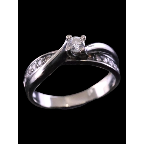 57 - A diamond solitaire set with diamond shoulders N set in 18ct gold