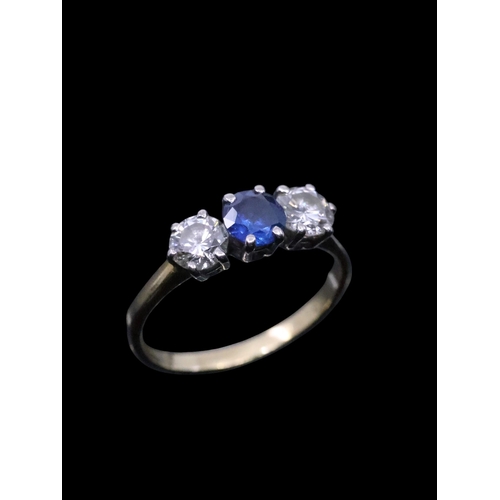 108 - A diamond and sapphire three stone ring set in 18ct gold, finger size K