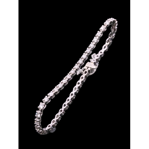 138 - A diamond line bracelet set in 18ct gold, total estimated weight of diamonds 4cts, with a valuation ... 