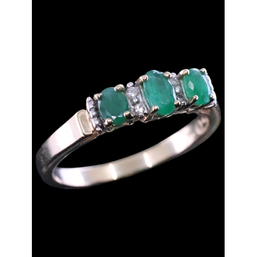 18 - An emerald and diamond cluster ring finger size N