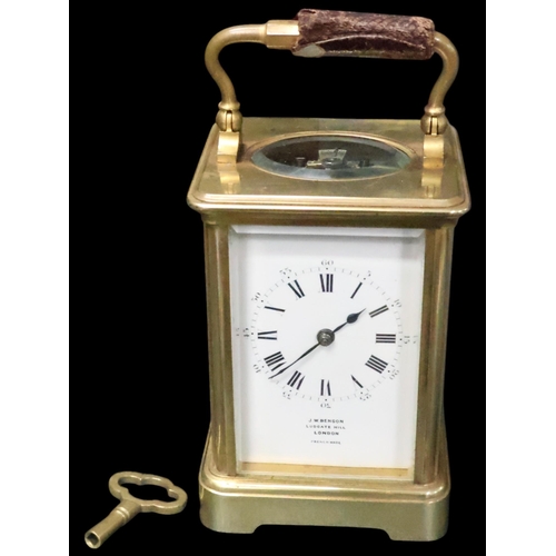 253 - A brass carriage clock in case with key by J W Benson London (French made)