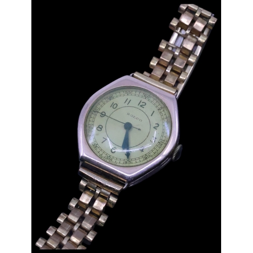 269 - A gold Rolco watch (Dublin import hallmarks 1927) (weight of back plate/case 3.7 grams)  on a metal ... 