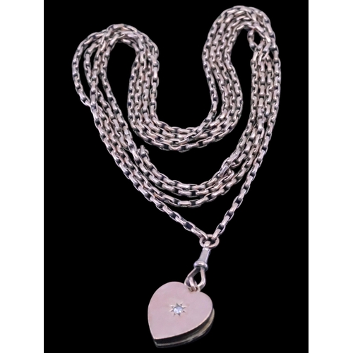 28 - An antique diamond set heart locket with a 9ct gold muffchain, total weight approx. 36 grams