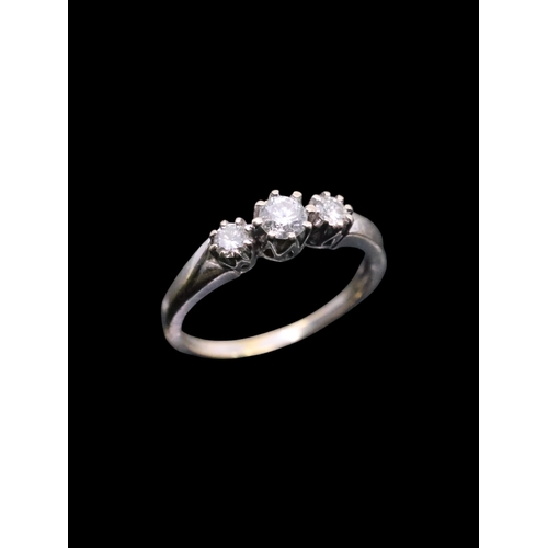 135 - A diamond three stone ring set in 18ct gold, approx. 2.9 grams finger size L