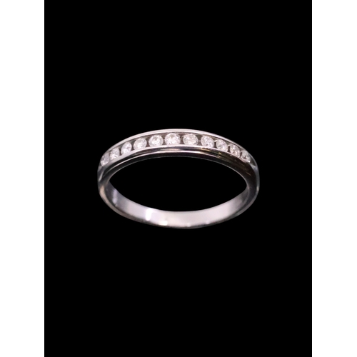 141 - A diamond half eternity ring set in 18ct gold, total estimated weight of diamonds 0.20cts finger siz... 