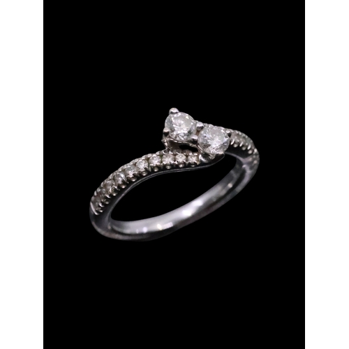 176 - A diamond two stone twist ring set in 14kt gold finger size J half approx. 3.6 grams