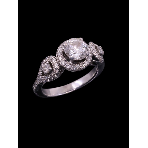 21 - A diamond three stone cluster ring with an IGI certificate for the main diamond which states the dia... 