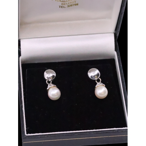 24 - A pair of pearl set 18ct gold earrings approx. 4.1 grams