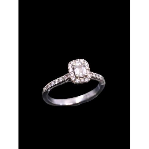 29 - An 18 carat white gold diamond baguette halo  ring, finger size J with copy of valuation which state... 