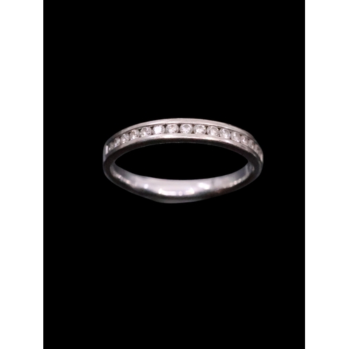 30 - An 18 carat white gold diamond half eternity ring, finger size J and a half with copy of valuation w... 