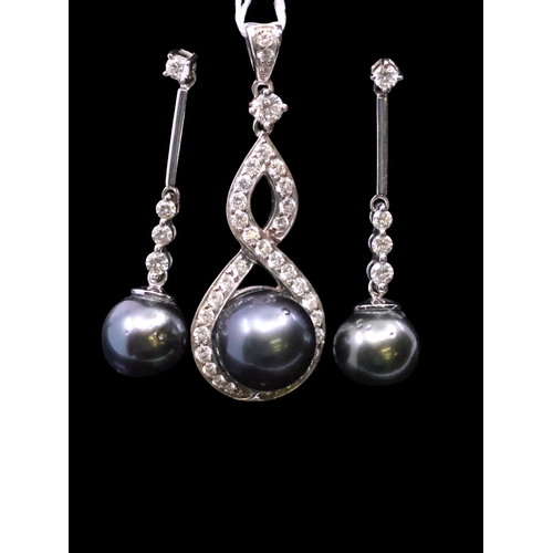 34 - A diamond and pearl set 18ct gold pendant and diamond and pearl set earrings total estimated weight ... 