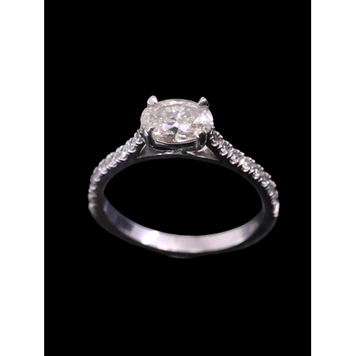 35 - A diamond solitaire ring set with diamond shoulders with a copy of a valuation which states the main... 