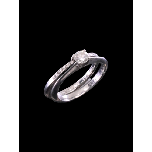 9 - A diamond solitaire ring set in platinum with a diamond set wedding band, total weight 7.2 grams fin... 